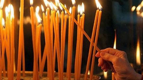 Imagine cu o biserică ortodoxă și lumânări aprinse