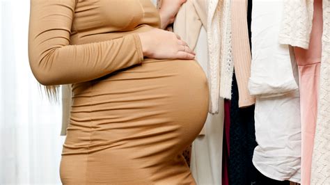 Femeie însărcinată alegând haine confortabile