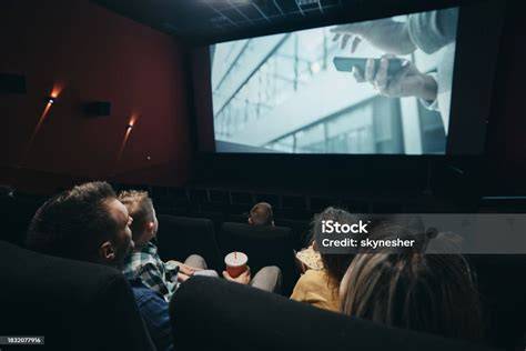 Imagine a unei familii care vizionează un film animat pe canapea, cu zâmbete mari