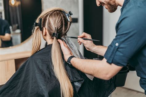 Femeie vopsindu-și părul într-un salon