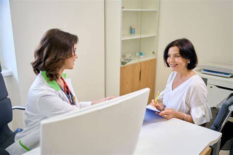 Fotografie: doctor și pacientă discutând planul de tratament postnatal