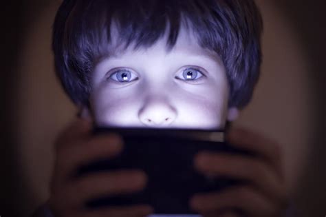 Copil jucându-se cu o cutie goală